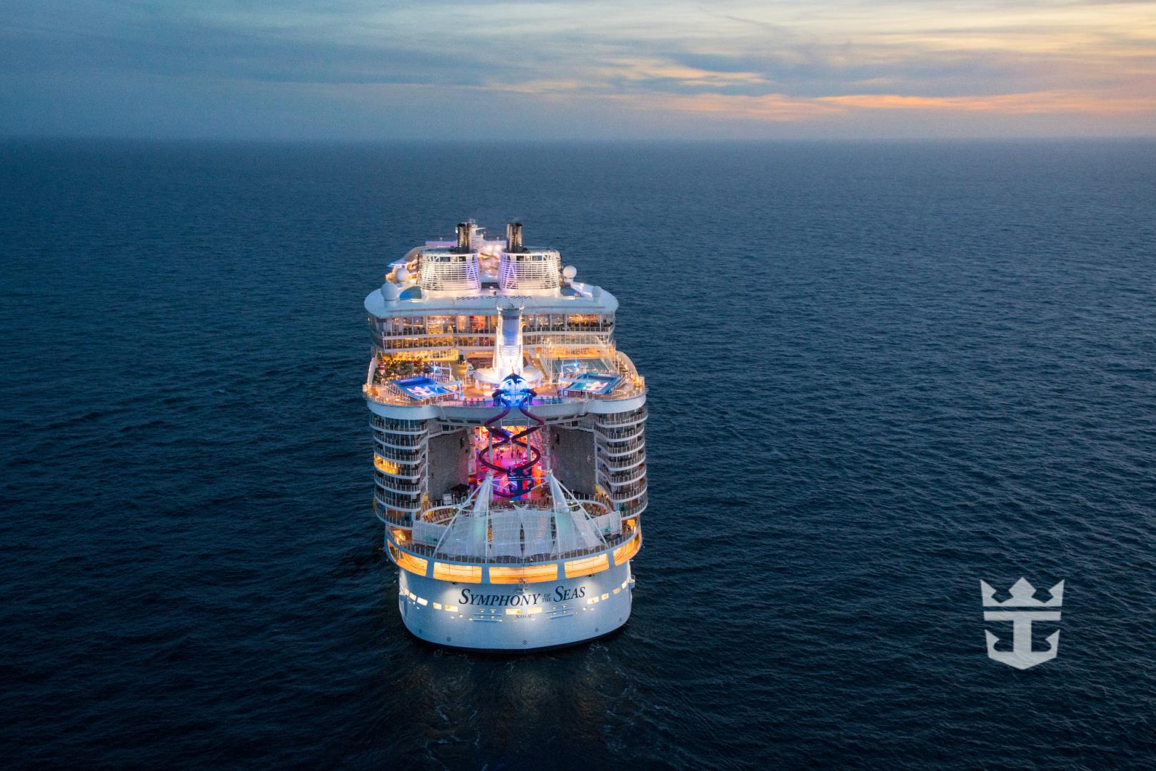 Aerial view of Symphony of the Seas at night offshore Barcelona, Spain